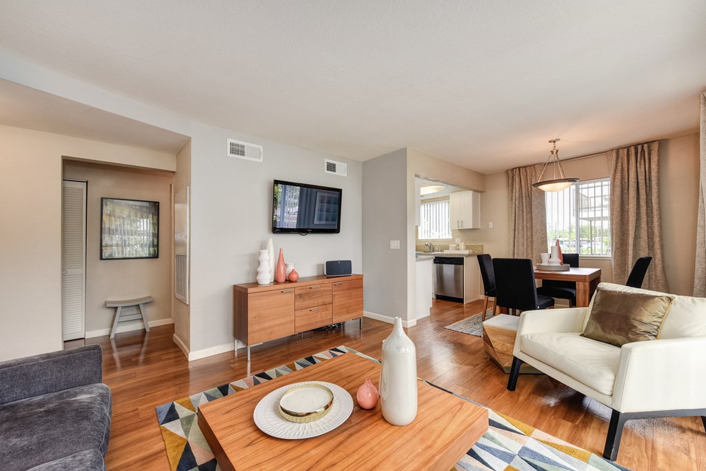 Living Room with Television with Wood Inspired Floor, White Sofa at Addison Ranch Apartments, Petaluma