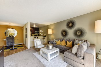 Living Room with View of Dining Area with Gray Sofa, Carpet and Hardwood Inspired Floors - Photo Gallery 4
