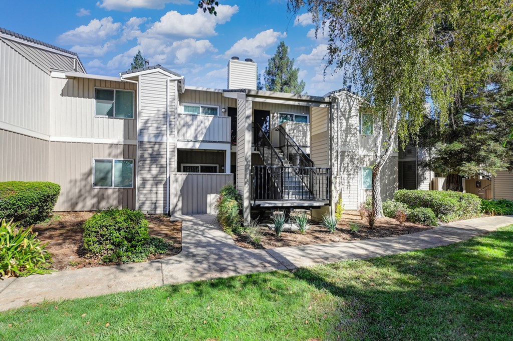 Monte Bello apartment building 2 levels and mature shade tree located in front of the building. at Monte Bello Apartments, Sacramento ,95826