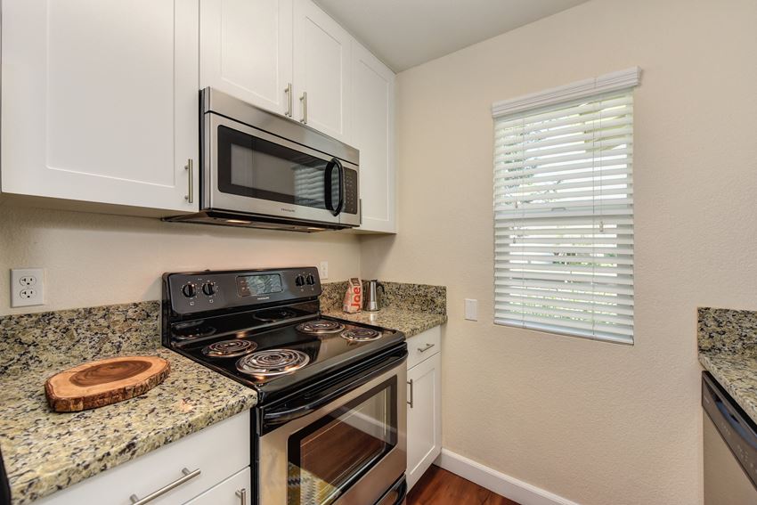 Kitchen with Granite Counters, Hardwood Inspired Floors, Microwave and Oven Kitchen with Granite Counters, Hardwood Inspired Floors, Microwave and Oven at Monte Bello Apartments, Sacramento ,95826 - Photo Gallery