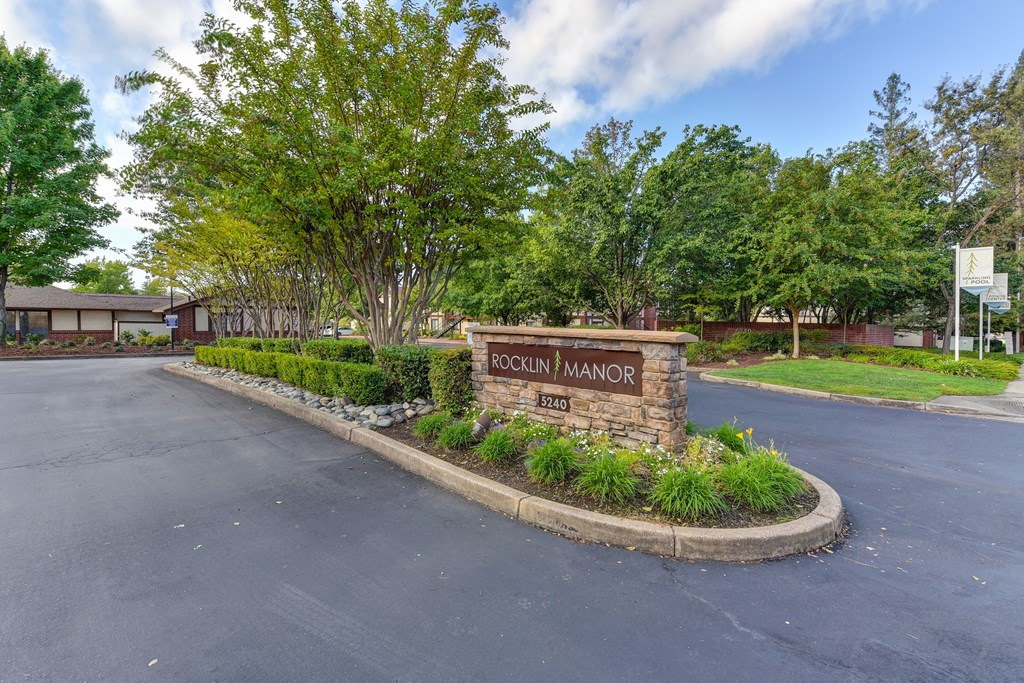 Rocklin Manor Monument Sign with Plant Bed, Road and Trees