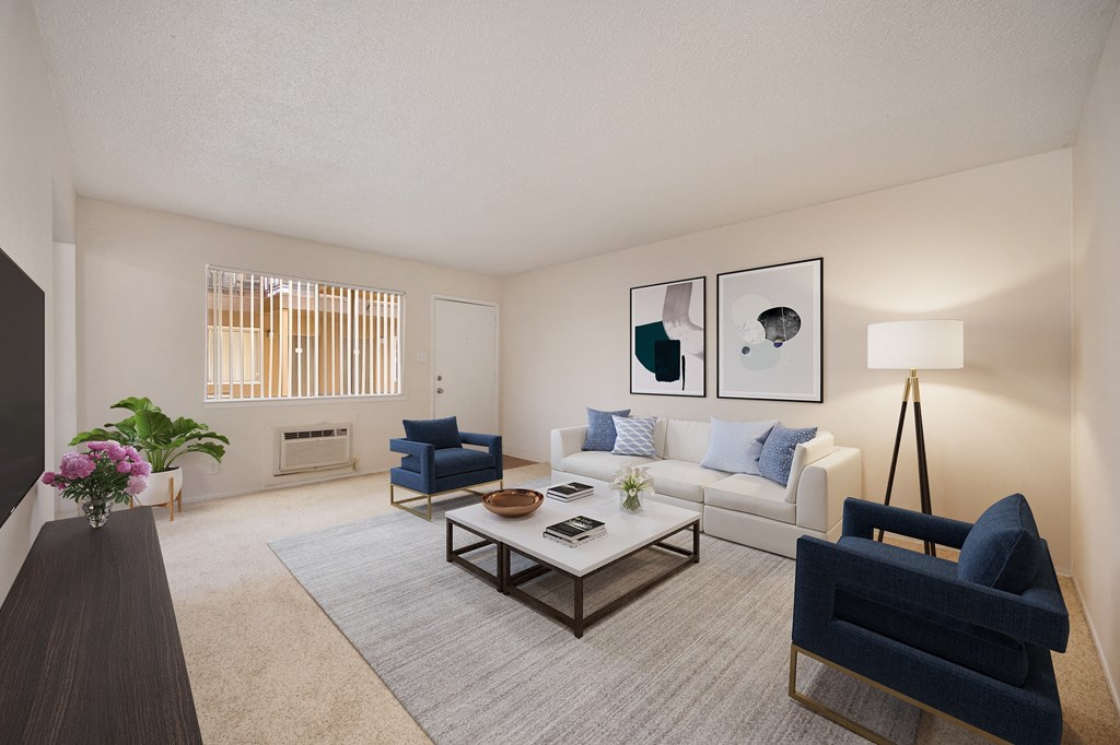 A living room with a blue chair and a coffee table.
