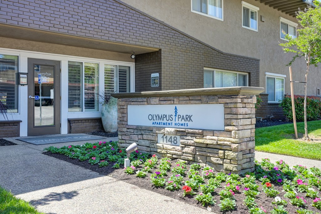 a brick building with a sign that reads owens park dental office  at Olympus Park Apartments, Roseville, CA, 95661