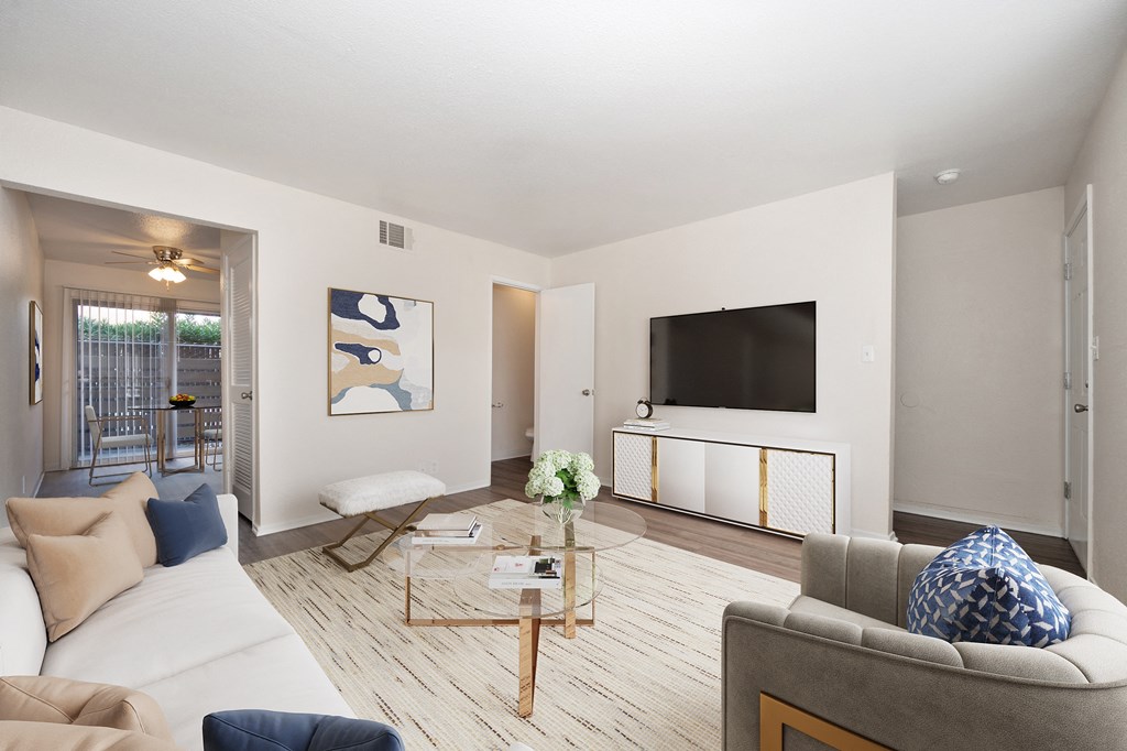 A living room with a grey couch and a coffee table.
