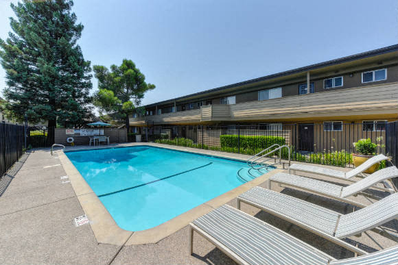 Outdoor Swimming Pool and Lounge Area with Lounge Chairs, Apartment Exteriors and Trees  at Olympus Park Apartments, Roseville, 95661