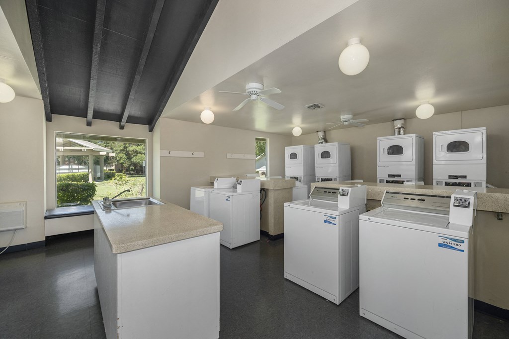 a room with washing machines and a sink
