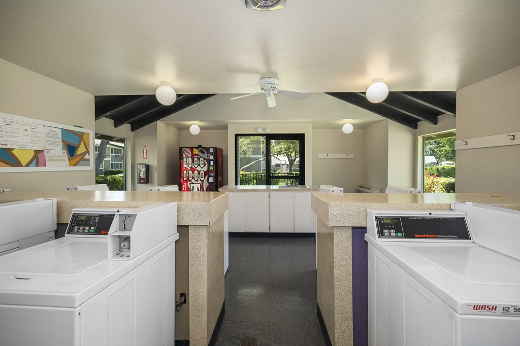 a laundry room with white washers and a washer and dryer
