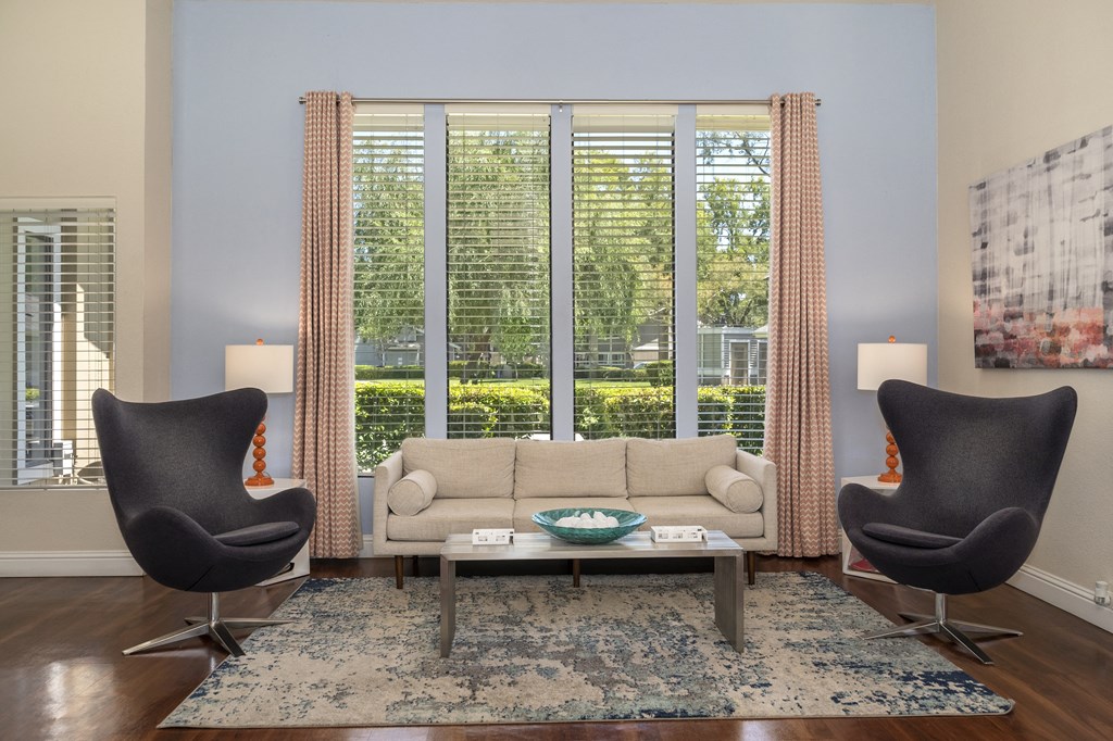 a living room with a couch and two chairs