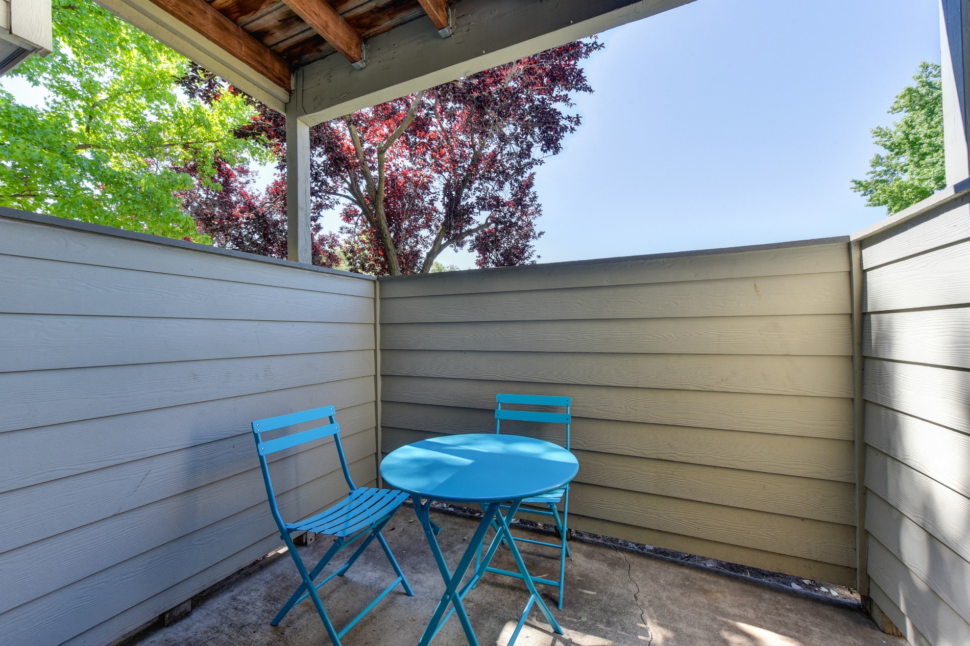 Private Patio Porch for Outdoor Space with Bliue Foldable Chairs, and Blue Table at Cobblestone Creek Apartments, California, 95661