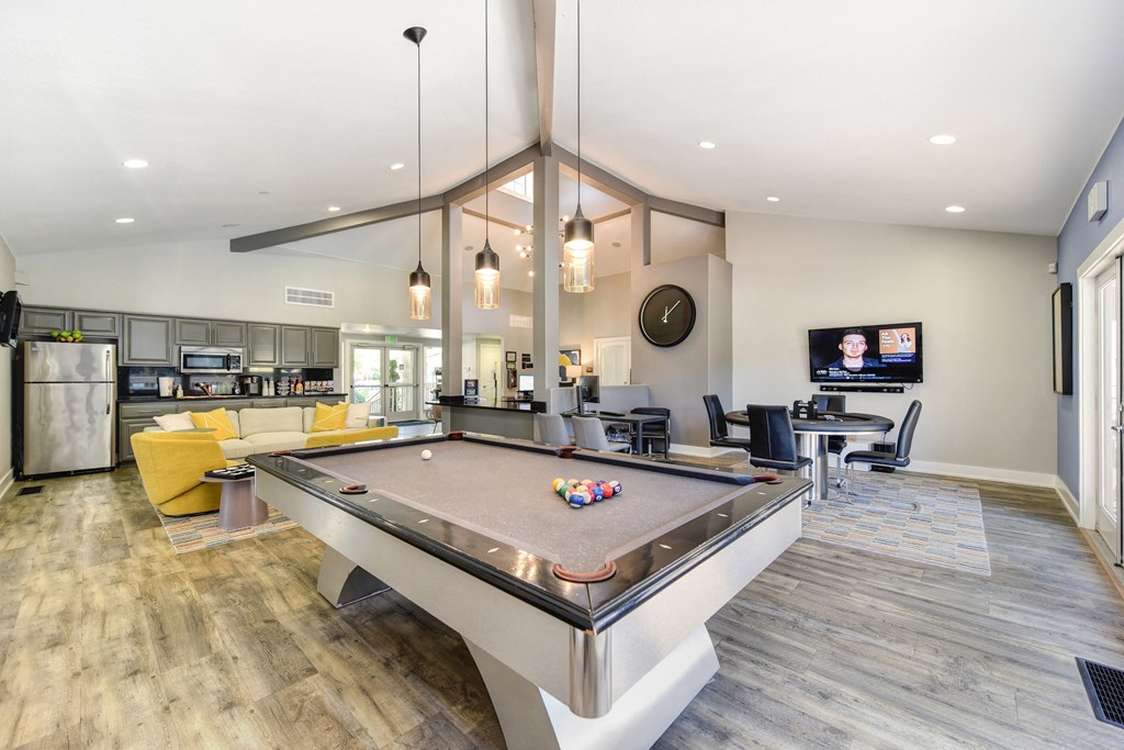 a resident clubhouse with a pool table and a flat screen tv at Renaissance Park Apartments, Davis ,36305