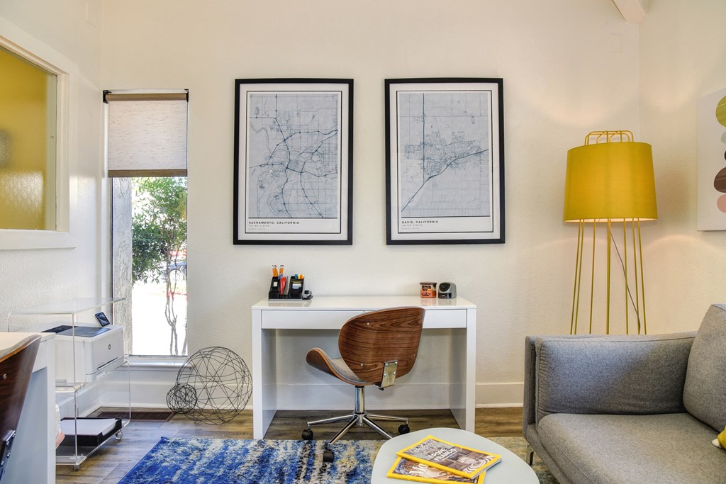 a home office with a white desk and a yellow lamp at Renaissance Park Apartments, Davis, CA