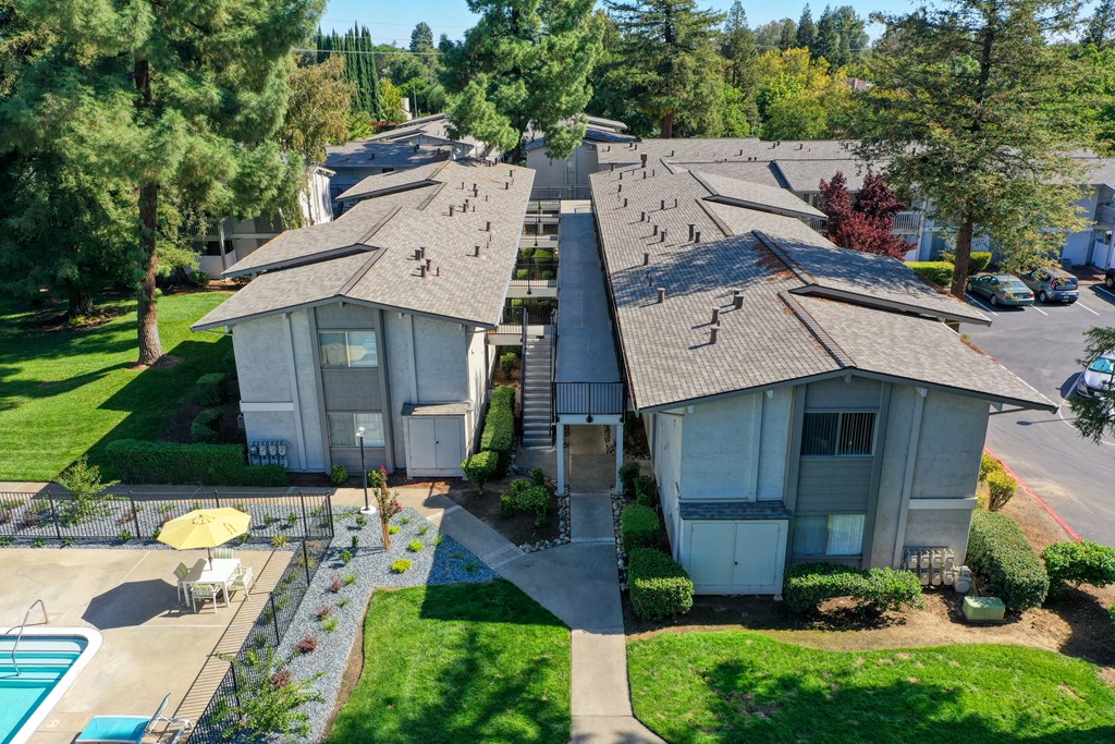 Ariel shot above the community overlooking the buildings, walk paths and community swimming pool. at Renaissance Park Apartments, California, 95618