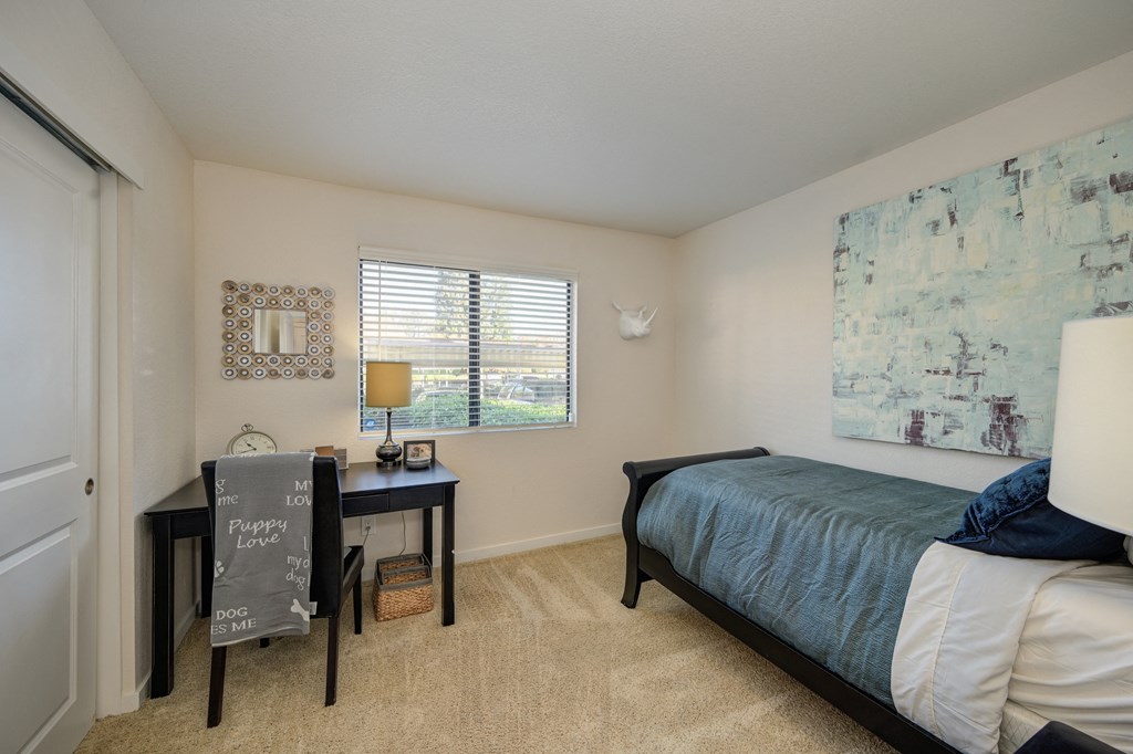Model Bedroom with twin size bed and work from home desk under the bedroom window at Rocklin Manor  Apartments, California, 95677