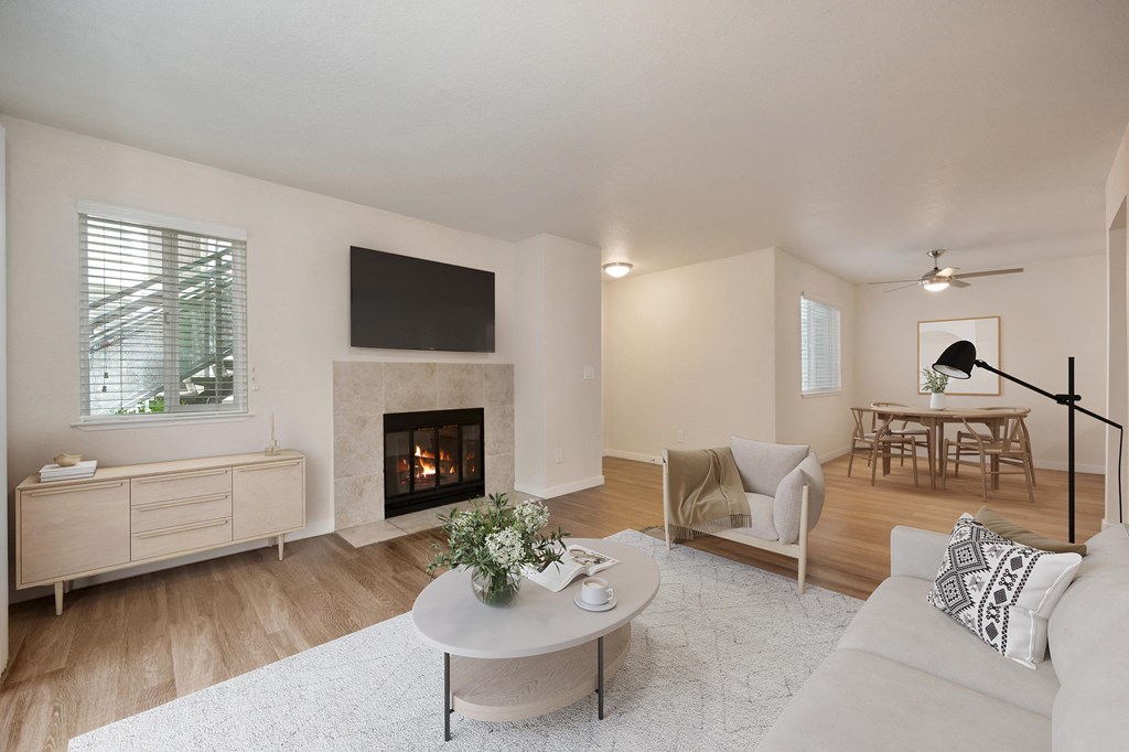 a living room with a fireplace and a white rug