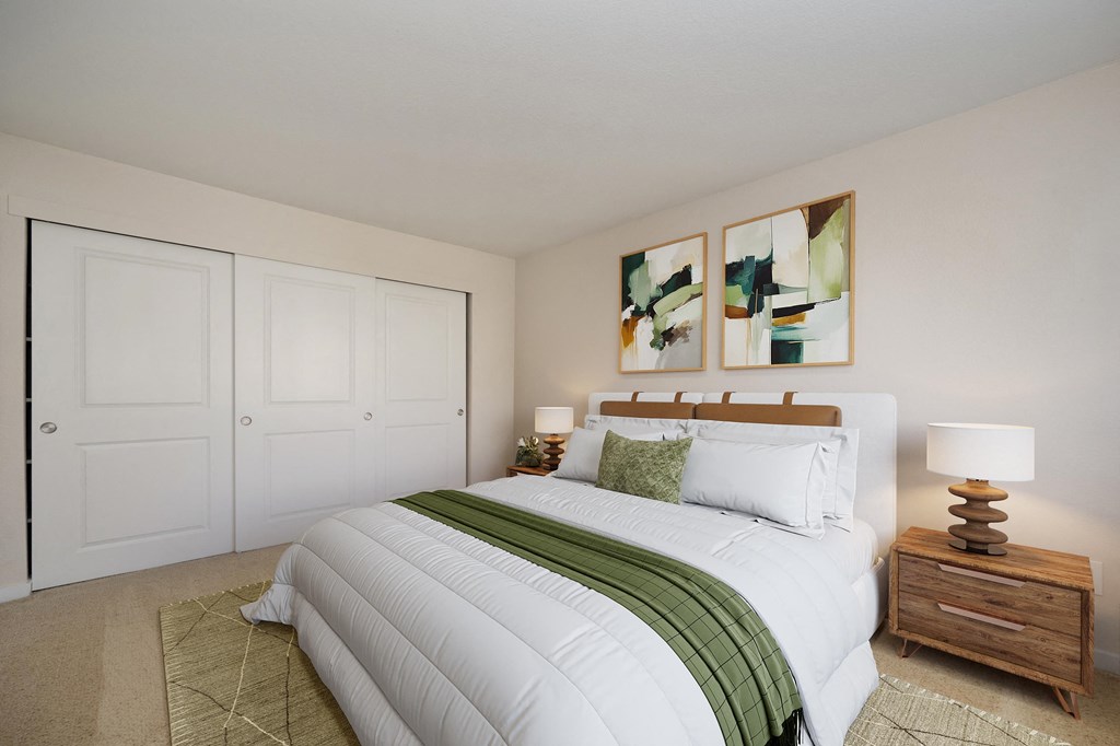 a bedroom with a large white bed and two paintings on the wall