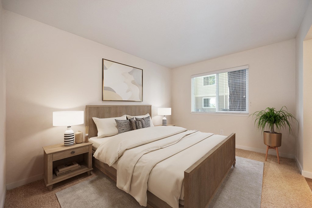 a bedroom with a large bed and a window