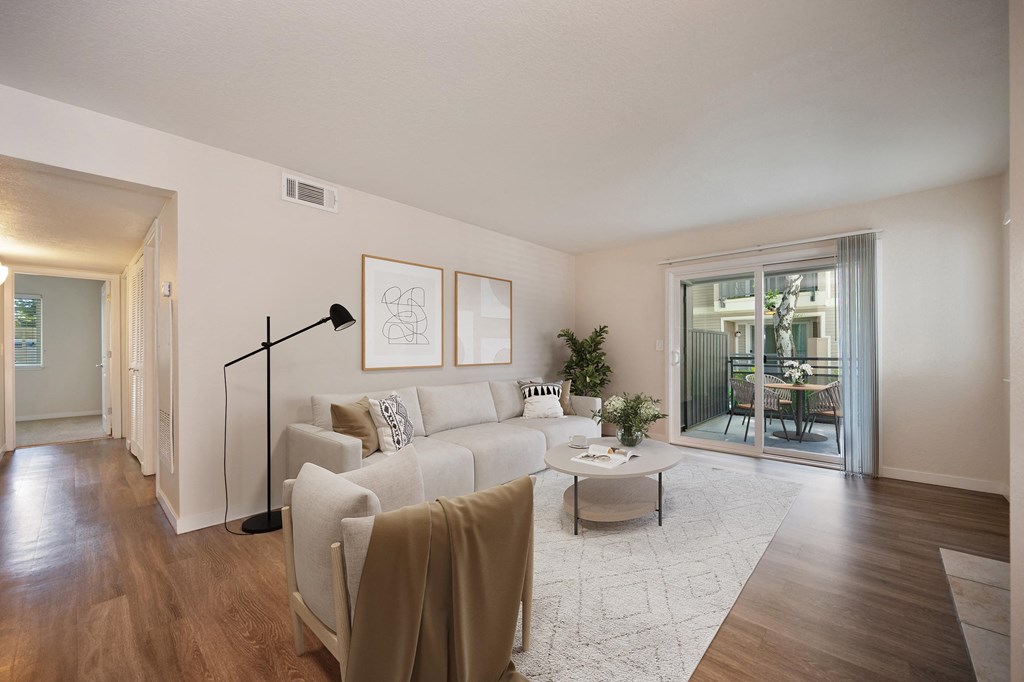 a living room with a white couch and a coffee table at Rush River Apartments, Sacramento