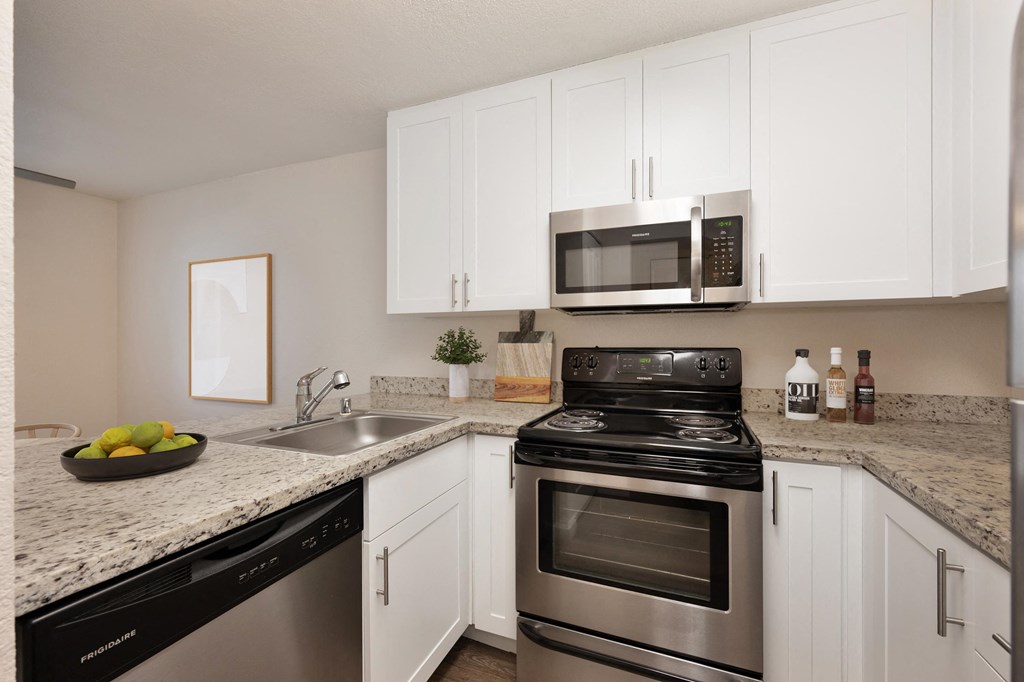 our apartments offer a kitchen with stainless steel appliances and granite counter tops at Rush River Apartments, Sacramento, CA, 95831