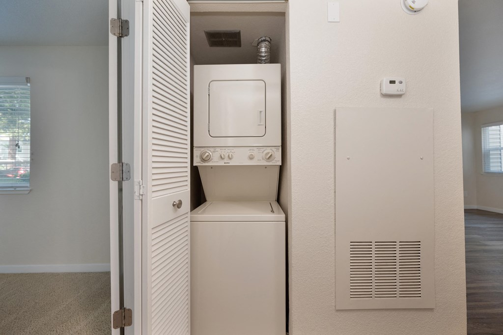 an empty laundry room with a washer and dryer in it at Rush River Apartments, Sacramento
