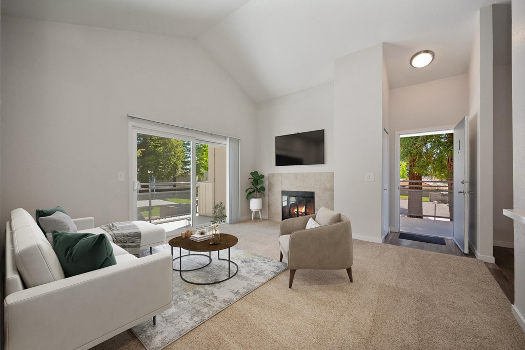 a living room with a couch and a chair and a fireplace at Rush River Apartments, California, 95831