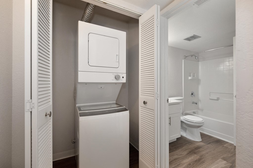 a small bathroom with a washer and dryer in a closet at Rush River Apartments, California