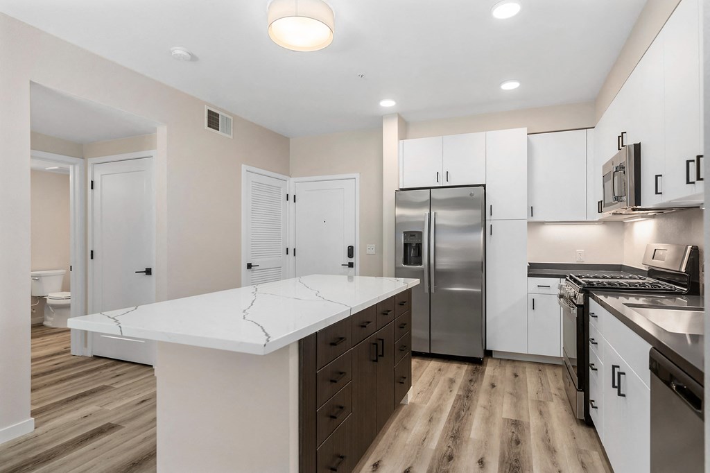 a renovated kitchen with white cabinets and stainless steel appliances at Sierra Gateway Apartments, Rocklin, CA