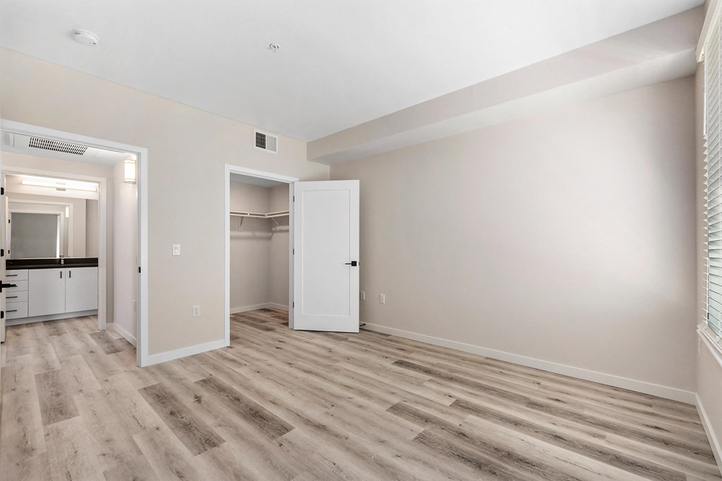 an empty living room with white walls and wood flooring at Sierra Gateway Apartments, California, 95677