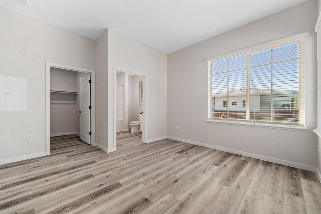 an empty room with a window and a door to a bathroom at Sierra Gateway Apartments, Rocklin