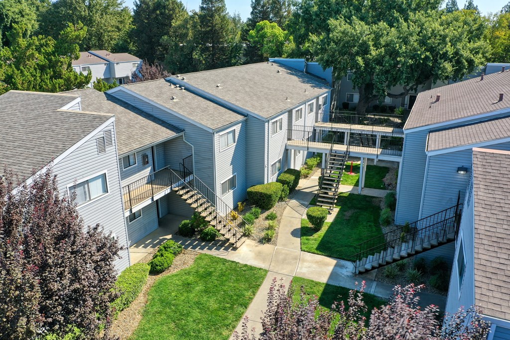 an aerial view of a row of houses with trees in the background at Silverstone Apartments, Davis, CA