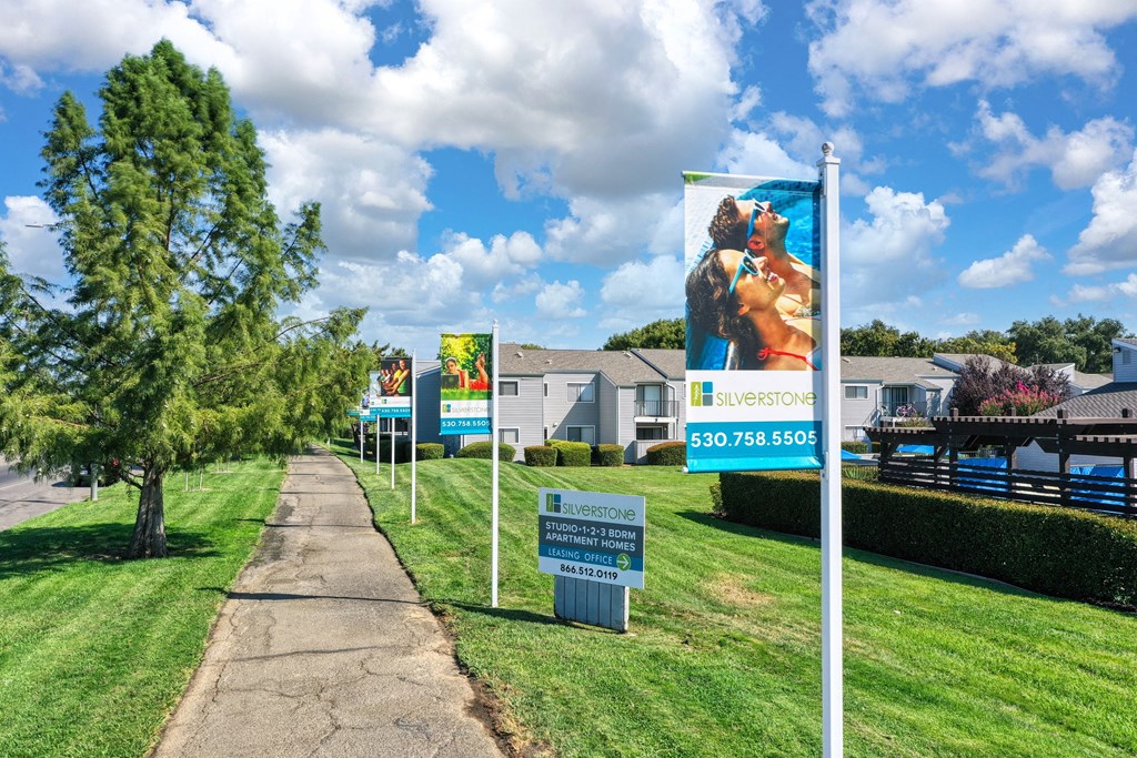 a row of signs in front of houses at Silverstone Apartments, Davis ,95618