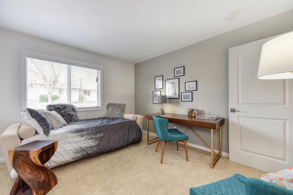 Spare Bedroom with Gray Daybed, Carpet, Wood Table, Turquoise Chairs and Windows at The Legacy Apartments, Antelope, 95843