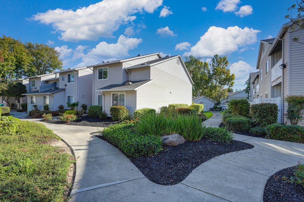 Community Grounds with walk paths, mature landscaping and views of the apartment buildings. at The Legacy Apartments, California, 95843