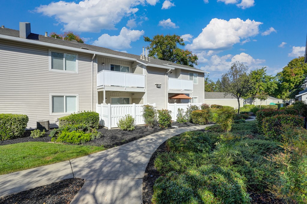 Community Grounds with walk paths, mature landscaping and views of the apartment buildings. at The Legacy Apartments, California, 95843
