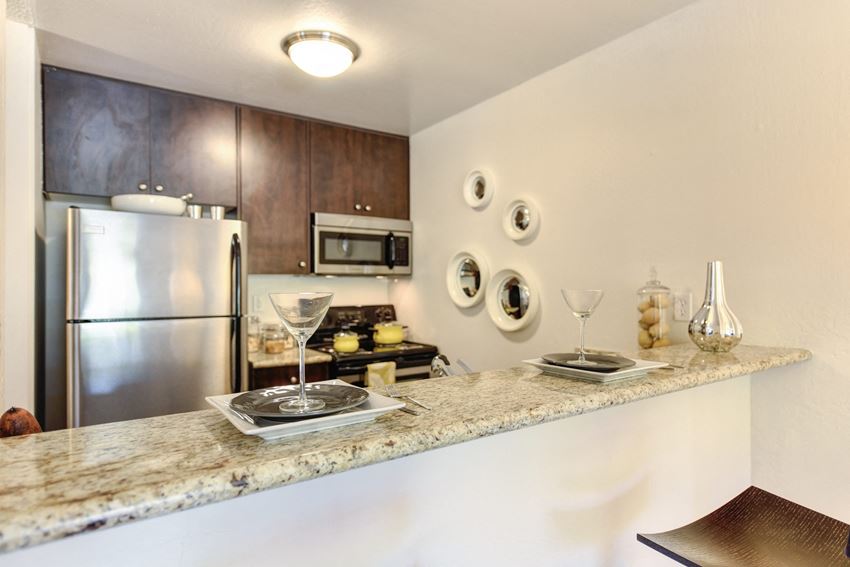 Kitchen a kitchen with granite countertops and stainless steel appliances