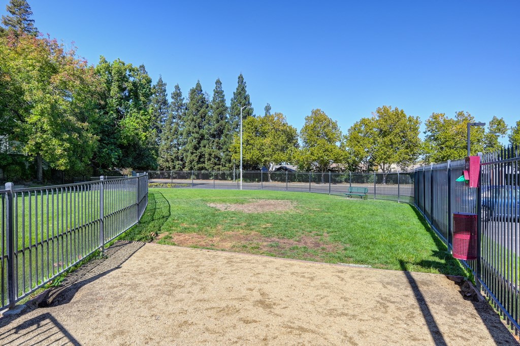 An on-site dog park/dog run area that is fenced for dogs to play and roam off leash. at The Legacy Apartments, Antelope, CA
