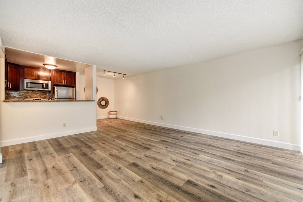 Vacant apartment home located on the first floor with hardwood inspired flooring through out with views of the open concept kitchen and front door. 