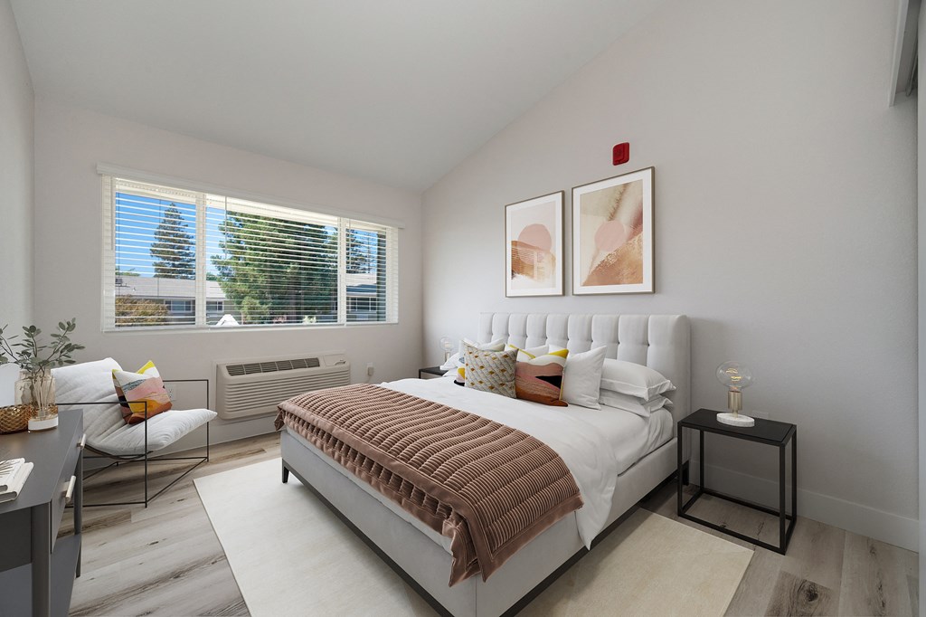 2 Bedroom, 2 Bathroom Home a bedroom with a bed and two windows at Track 281 Apartments, Sacramento, CA, 95811