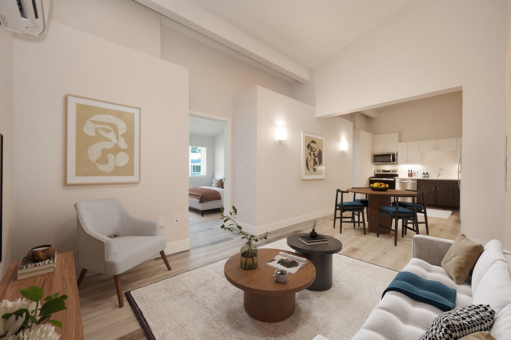 a living room with a couch and a table and a kitchen in the background  at Track 281 Apartments, Sacramento, CA