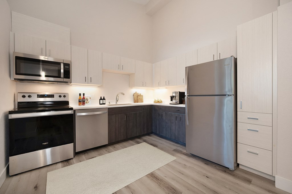 a modern kitchen with stainless steel appliances and white cabinets  at Track 281 Apartments, Sacramento, CA, 95811