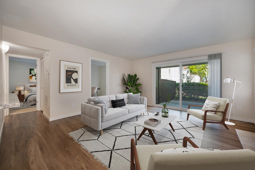 a living room with white furniture and a sliding glass door at Rush River Apartments, Sacramento, CA, 95831