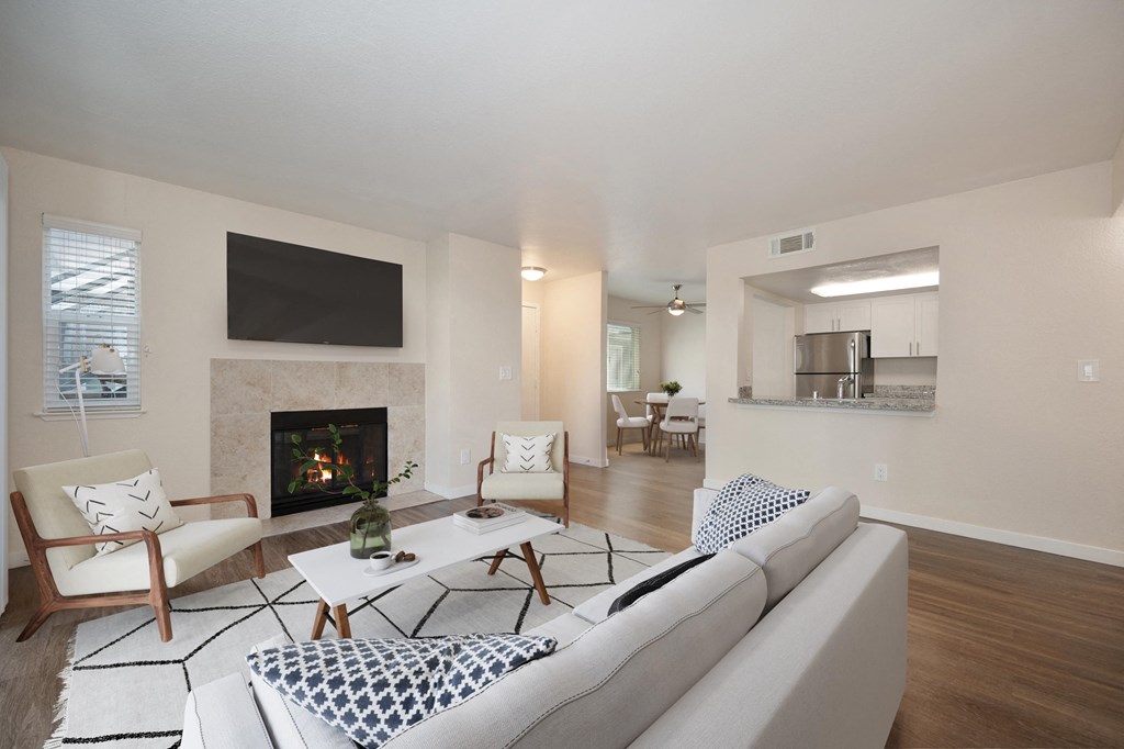 a living room with a fireplace and a couch at Rush River Apartments, California, 95831