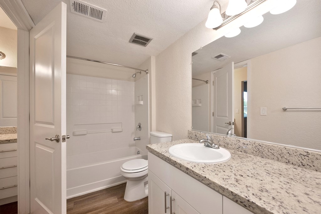 a bathroom with a sink and a toilet and a shower at Rush River Apartments, Sacramento, CA