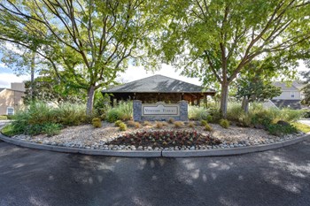 Vineyard Terrace community entrance with monument signage and mature trees on each side.  - Photo Gallery 37