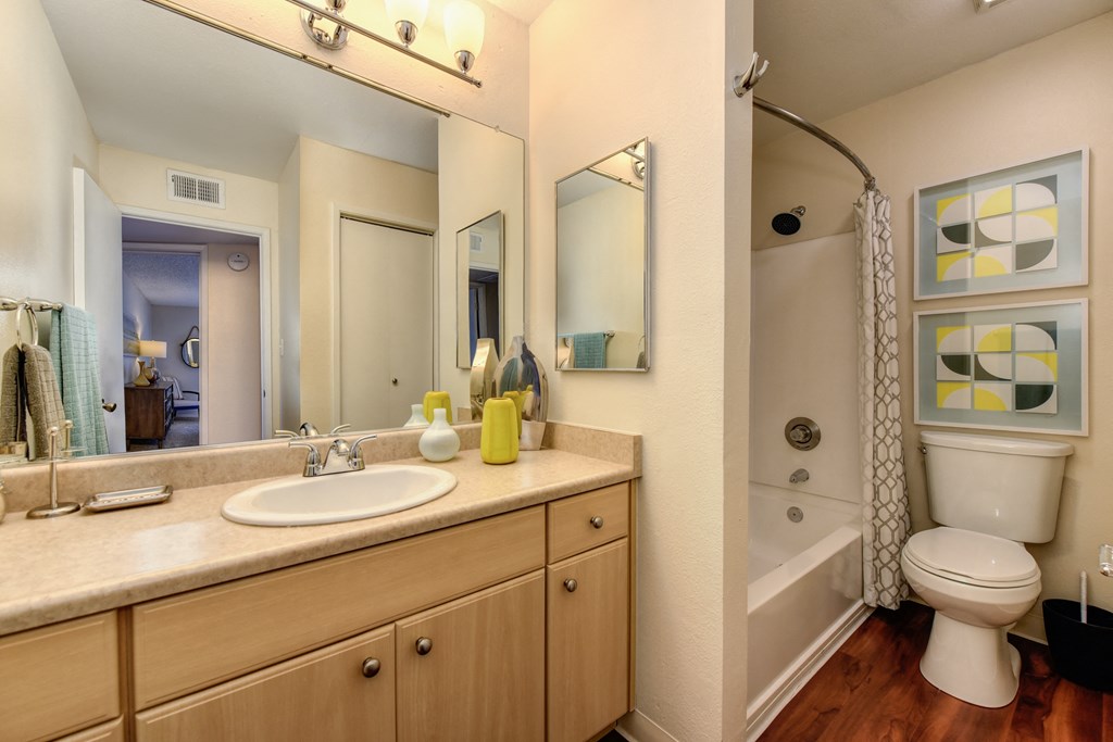 Model bathroom with long sink vanity counters, one sink, tub/shower enclosure and toilet at Vineyard Terrace Apartments, California 94558