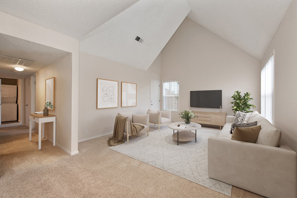 the living room of an apartment with a couch and a tv at Vineyard Terrace Apartments, Napa, CA