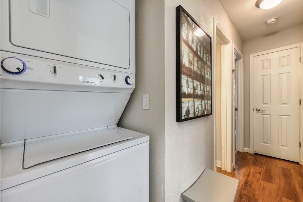 Washer Dryer with Wood Inspired Floor, White Doors, Ceiling Lights at Addison Ranch Apartments, Petaluma, CA, 94954