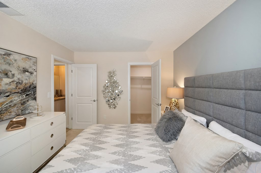 a bedroom with a large bed and a closet