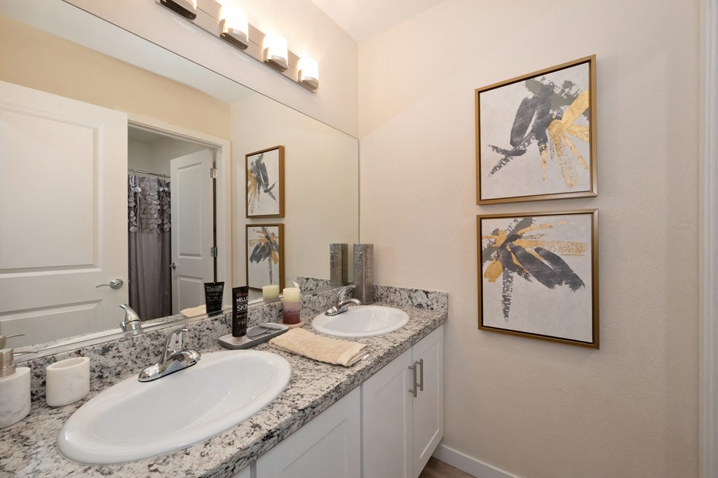 Bathroom with Granite Countertops, Vanity and Framed Abstract Paintings