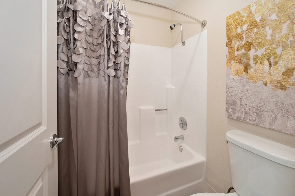 a bathroom with a shower curtain and a toilet