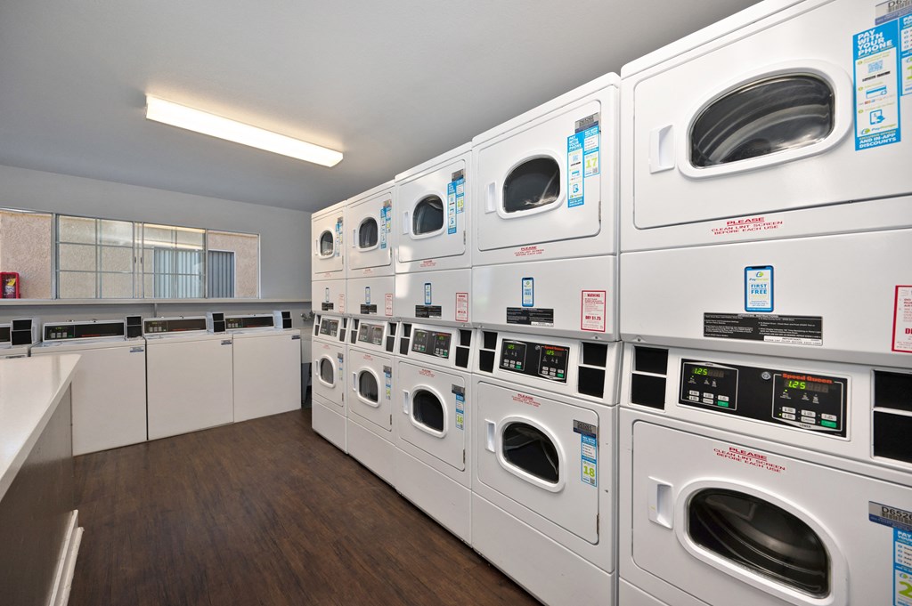 a row of washing machines in a laundry room